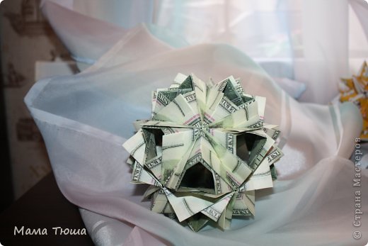 "Этна"
автор Мария Синайская
диаграмма  http://goorigami.com/diagrams/etna-kusudama
сделана из 100 долларовых купюр 
без клея (фото 4)