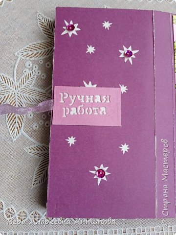 Вот так сзади: прямоугольник с вырубкой "ручная работа" держит ленту, на больших звездочках пайетки. (фото 5)